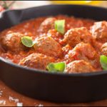 meatballs with tomato sauce in black pan